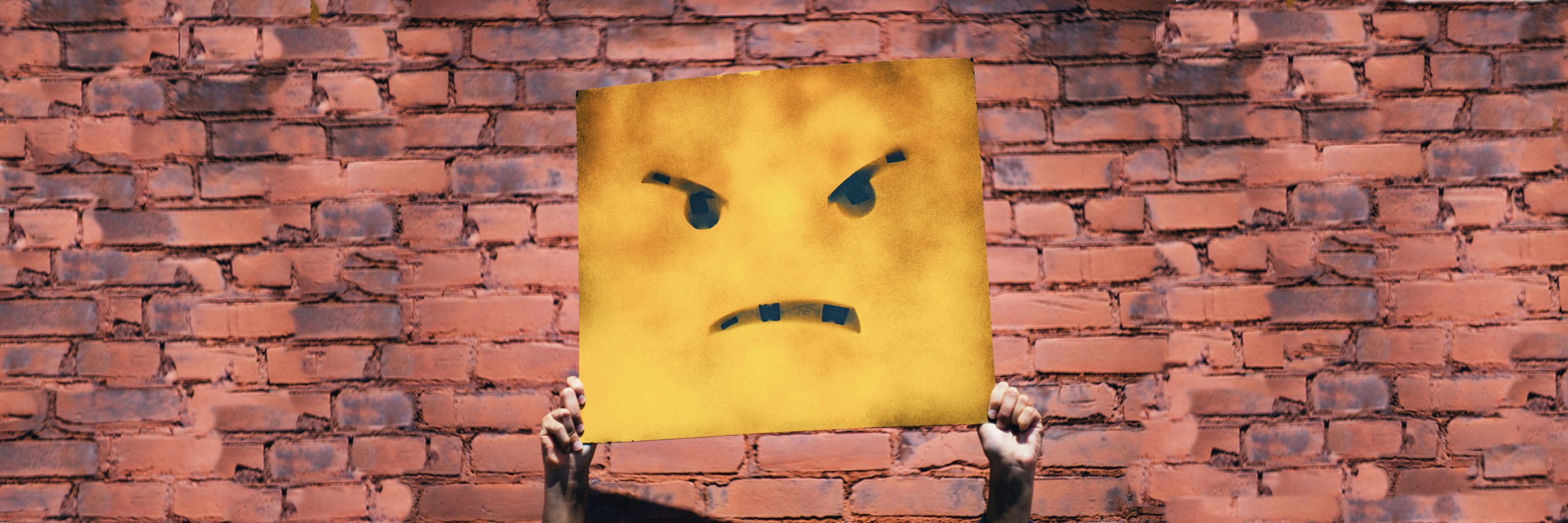 Frustrated face by wall